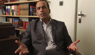 Masoud Shafiei, the Iranian lawyer for two Americans who have been jailed in Iran on charges of espionage, speaks at his office in Tehran, Iran, on July 30, 2011. (Associated Press)