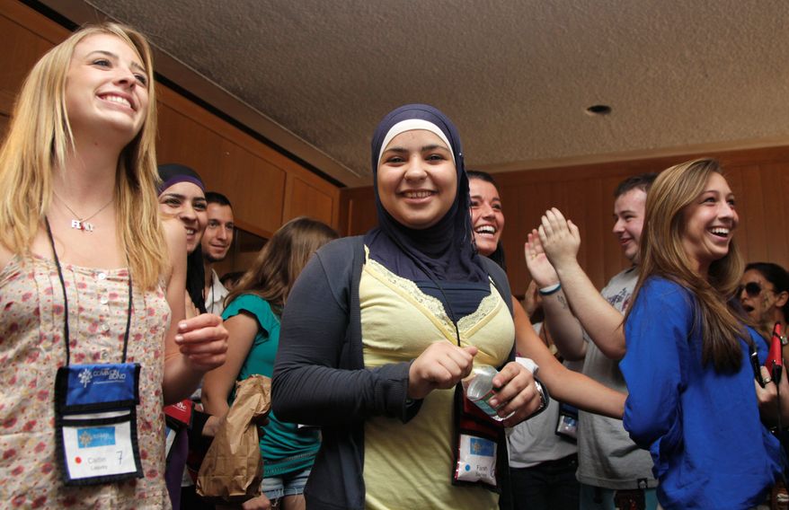 Associated Press
From left: Caitlin Leavey, Farrah Sarrawi, Francesca Picerno and Allison Stahlman are applauded during Project Common Bond in Middlesburg, Va. The camp has an international focus that helps participants forge lasting friendships.