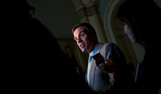 ** FILE ** Sen. Mark R. Warner, Virginia Democrat, speaks with reporters on Capitol Hill in Washington on Tuesday, Aug. 2, 2011, after the Senate passed the debt ceiling plan. (The Washington Times)
