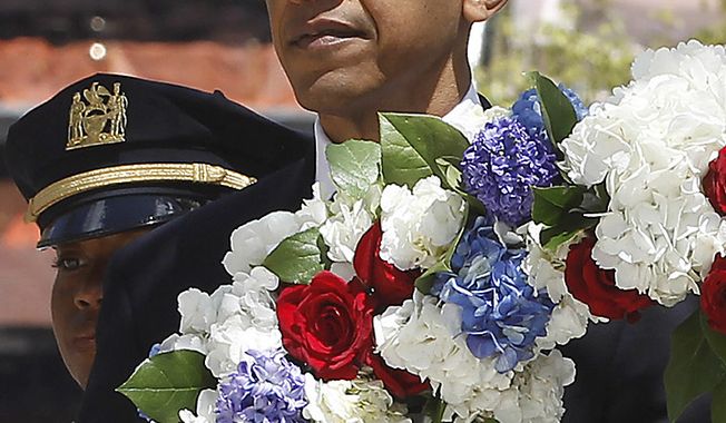 **FILE** President Obama lays a wreath at the National Sept. 11 Memorial at Ground Zero in New York on May 5, 2011. (Associated Press)