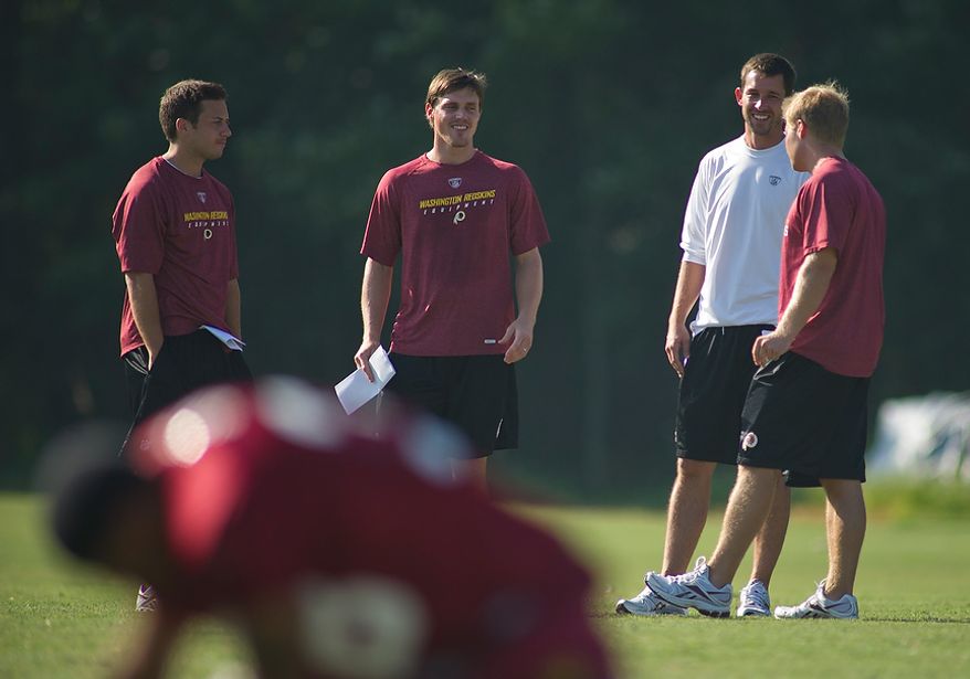 Washington Redskins Offense Coordinator Kyle Shanahan (second from right) chats with tight ends coach Sean McVay (right) and Coaching Assistant Richmond Flowers (second from left) during training camp at Redskins Park in Ashburn, Va., Tuesday, August 2, 2011. The man at far left is unidentified. (Rod Lamkey Jr./The Washington Times)