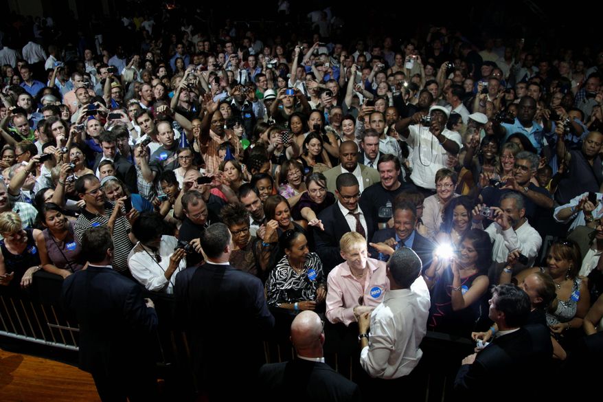 President Obama greets attendees after speaking at the Aragon Ballroom in Chicago on Wednesday at a fundraiser on the eve of his 50th birthday. (Associated Press)