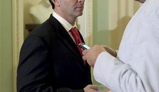 **FILE** Rep. Jeff Landry (left), Louisiana Republican, talks with an aide outside of the Senate Chamber on Capitol Hill on July 29, 2011. (Associated Press)