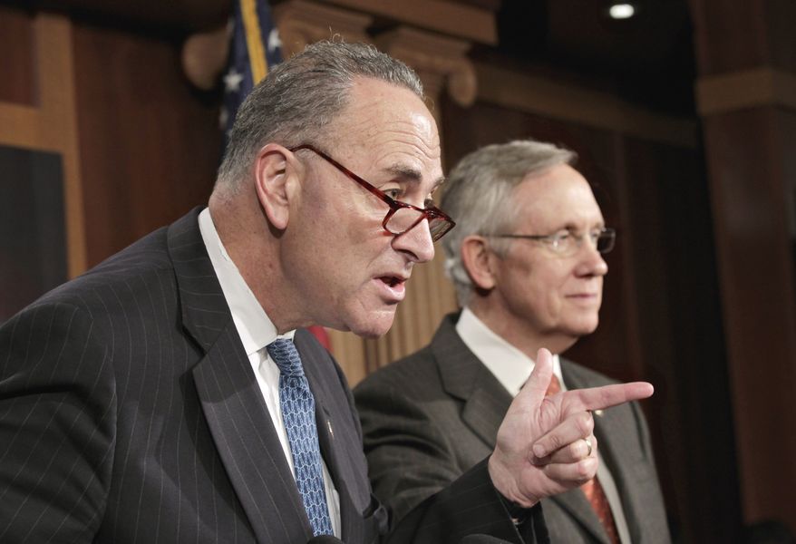 Sen. Charles Schumer (left), New York Democrat, accompanied by Senate Majority Leader Harry Reid, Nevada Democrat, gestures during a news conference on Capitol Hill on Aug. 3, 2011, to discuss the partial shutdown of the Federal Aviation Administration. (Associated Press)