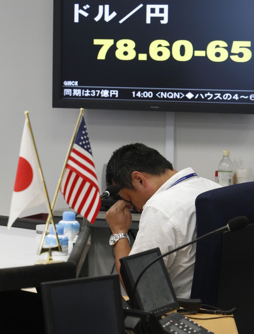 A money trader reacts in front of a monitor for the yen-dollar exchange rate at a money market brokerage firm in Tokyo Friday, Aug. 5, 2011. Asian stock markets tumbled Friday amid fears the U.S. may be heading back into recession and Europe's debt crisis is worsening. The sell-off follows the biggest one-day points decline on Wall Street since the 2008 financial crisis. (AP Photo/Shizuo Kambayashi)