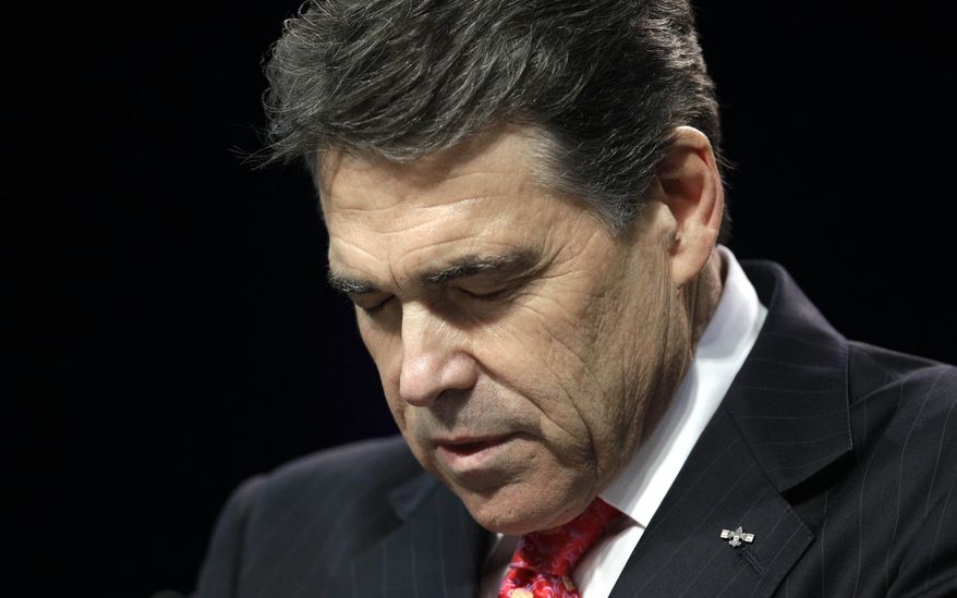 Texas Gov. Rick Perry bows his head as he leads a prayer at The Response, a call to prayer for a nation in crisis, Saturday, Aug. 6, 2011, in Houston. Perry attended the daylong prayer rally despite criticism that the event inappropriately mixes religion and politics. (AP Photo/David J. Phillip)