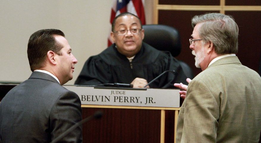 ASSOCIATED PRESS PHOTOGRAPHS
Casey Anthony's defense team, Jose Baez and Cheney Mason, confers with Judge Belvin Perry during a hearing at the Orange County courthouse on Friday. Judge Perry is deciding whether Casey Anthony has to return to Florida to serve probation for check fraud. Miss Anthony did not attend the hearing.