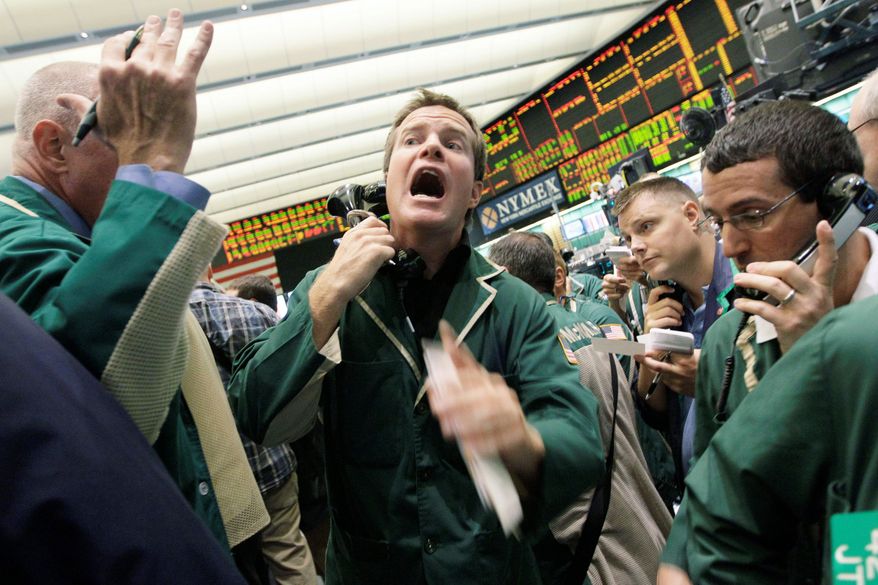 Traders work the crude oil options pit at the New York Mercantile Exchange on Friday in New York. Last week's stock market drop and fears of the lingering sour economy have already begun to put downward pressure on oil, which analysts said will translate to lower pump prices at stations around the country. (Associated Press)