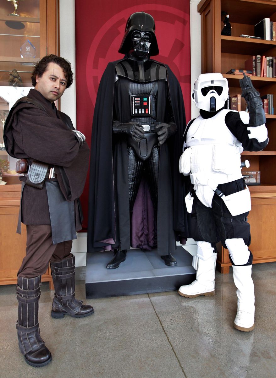 ** FILE ** "Star Wars" fans Matt Tolosa (left), dressed as Anakin Skywalker, and his brother Dale, dressed as a Stormtrooper, pose with a Darth Vader mannequin at the Lucasfilm Ltd. headquarters in San Francisco.(Associated Press)