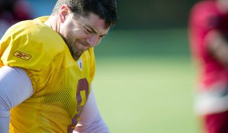 ROD LAMKEY JR./THE WASHINGTON TIMES
Redskins quarterback Rex Grossman, doing stretching exercises Monday, is locked in a battle with John Beck to be the starter.