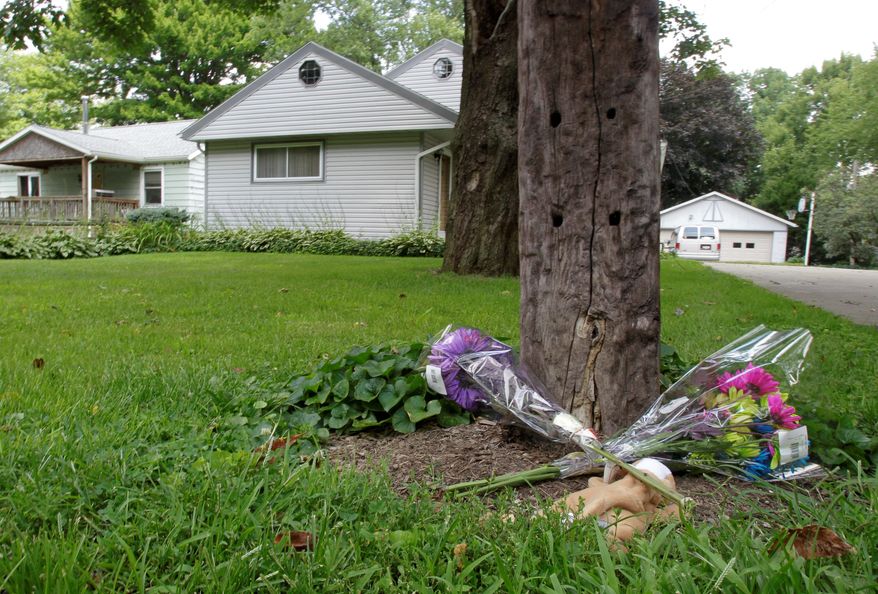 ASSOCIATED PRESS PHOTOGRAPHS
A small memorial sits next to a mailbox post near the scene of Sunday's shooting deaths in Copley, Ohio, on Monday. A man shot two people outside an Ohio home and two more in a car, then shot his girlfriend in a rampage that left eight dead, including the gunman, who was shot by police, authorities and witnesses said.