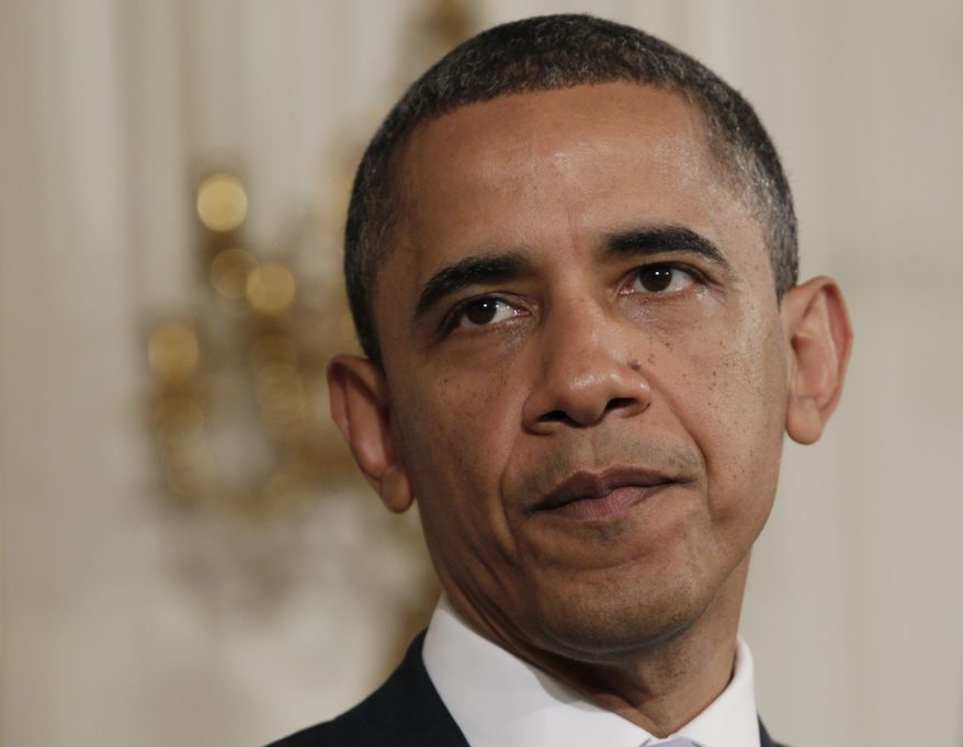 President Obama pauses as he speaks in the State Dining Room of the White House on Monday, Aug. 8, 2011, in Washington. (AP Photo/Carolyn Kaster)