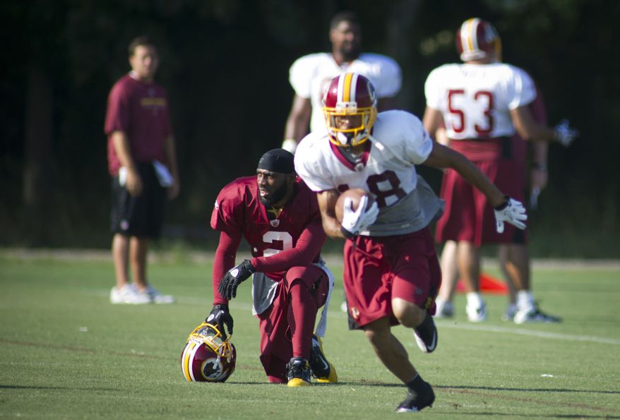 Washington Redskins cornerback DeAngelo Hall (left) takes a rest during training camp at Redskins Park in Ashburn, Va., on Monday, Aug. 8, 2011. (Rod Lamkey Jr./The Washington Times)