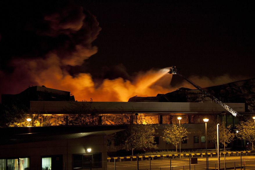 Firefighters fight a blaze at the Sony warehouse that was allegedly set alight, early Tuesday, Aug. 9, 2011 during unrest in Enfield, North London. Violence and looting raged across London and spread to three other major British cities on Tuesday, as authorities struggled to contain the country's most serious unrest since race riots set the capital ablaze in the 1980s. (AP Photo/Karel Prinsloo)