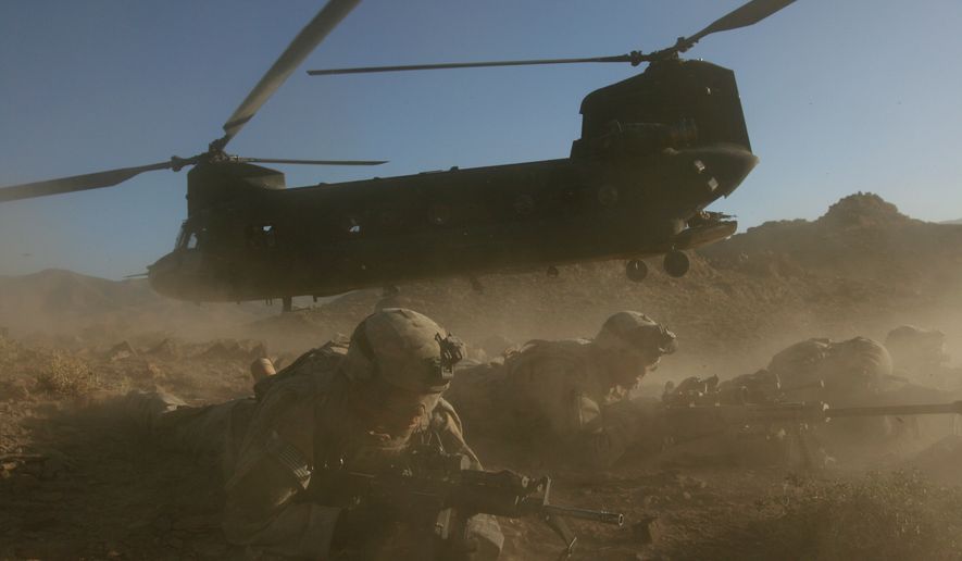 **FILE** U.S. soldiers from the 2nd Brigade, 87th Infantry Regiment, 10th Mountain Division, secure the area after exiting a Chinook helicopter, Helmand Province, southern Afghanistan, on June 18, 2006. Insurgents shot down on Aug. 6, 2011, a U.S. military helicopter similar to this one shown during fighting in eastern Afghanistan, killing 30 Americans, most of them belonging to the same elite Navy SEALs unit that killed Osama bin Laden, as well as seven Afghan commandos, U.S. officials said. (Associated Press)