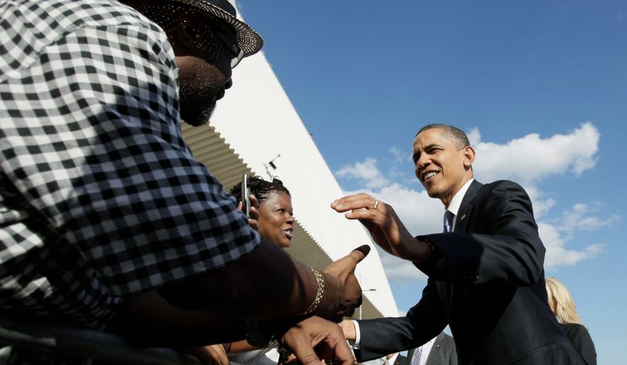 President Obama shakes hands on the tarmac at John F. Kennedy International Airport Thursday on his way to fundraisers in New York. (Associated Press)