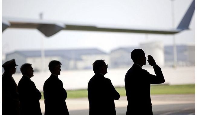 White House image of President Obama during the dignified transfer of remains of troops killed in Afghanistan, Dover AFB, August 9, 2011.