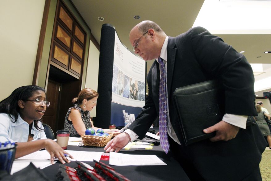 Job seeker Ted Koblick speaks with recruiter Catrina Stagnato during a Career Job Fair in Arlington, Va., on Aug. 4, 2011. (Associated Press)
