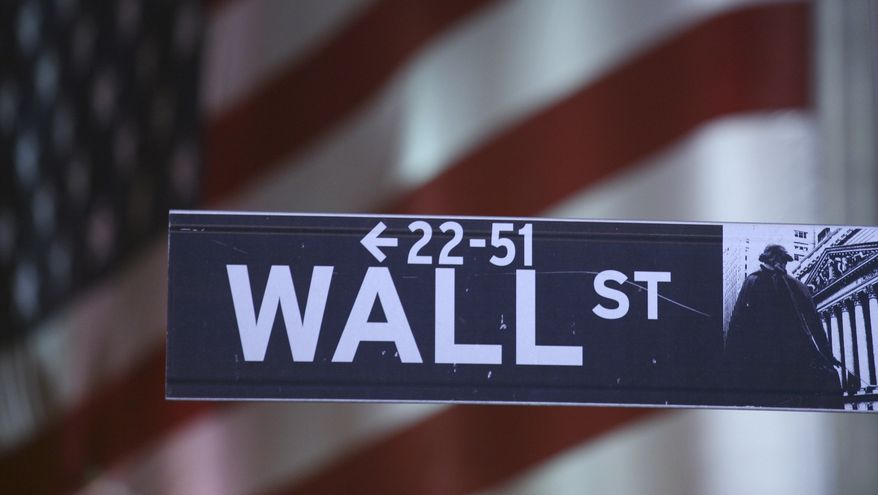 **FILE** A sign marks Wall Street in New York. (Associated Press)