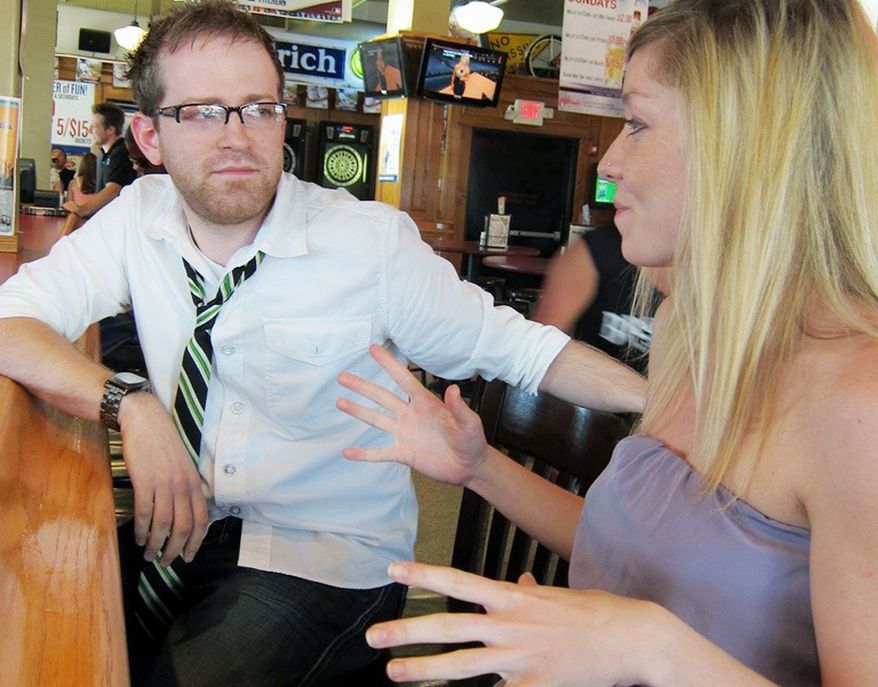 Joshua Mitchell, founder of the wing-woman service Miss Pivot, gives new recruit Lacy Meyer tips at an Indianapolis bar. For $20 to $50 per hour, professional wing women facilitate conversation with women whom their male clients might not otherwise approach. "There's so much to learn, and what I'm learning is really helping me in my personal relationships," Ms. Meyer said. (Photo courtesy of Miss Pivot)