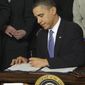 President Obama signs the health care bill in the White House on March 23, 2010. (Associated Press) **FILE** 