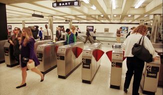 ** FILE ** Commuters enter and exit a Bay Area Rapid Transit (better known as BART) station in San Francisco&#39;s financial district in this Sept. 15, 1997, file photo. (AP Photo/Robin Weiner, File)