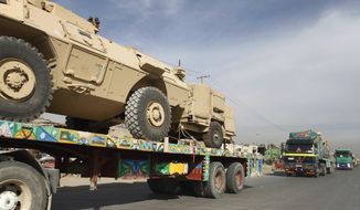 ** FILE ** A convoy of trucks carries U.S. equipment in Kabul, Afghanistan, on Jan. 17, 2010. (Associated Press)