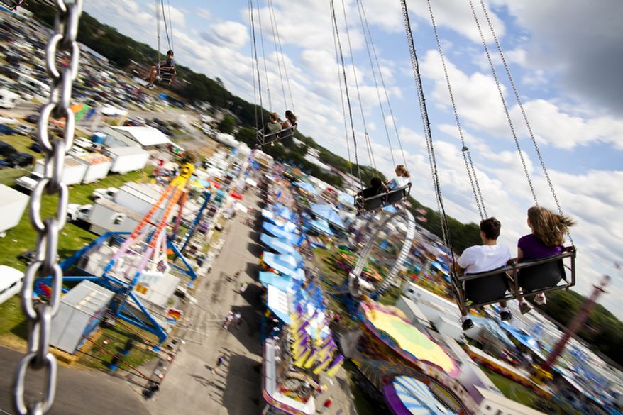 Fairgoers ride "Vertigo" at the 2011 Montgomery County Agricultural Fair in Gaithersburg, Md. on Tuesday, August 16, 2011. (Pratik Shah/The Washington Times)
