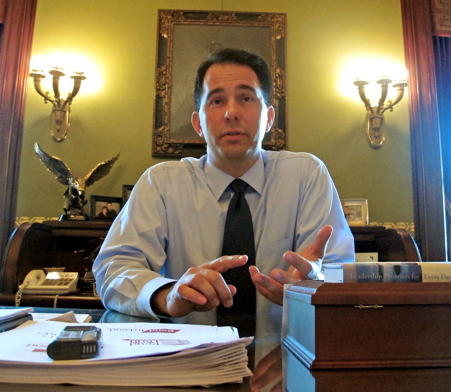 ** FILE ** Wisconsin Gov. Scott Walker, in Madison, Wis., on Wednesday, Aug. 10, 2011, discusses results of recall elections in which four incumbent Republicans in the Legislature held on to challenges from Democrats. (AP Photo/Scott Bauer, File)