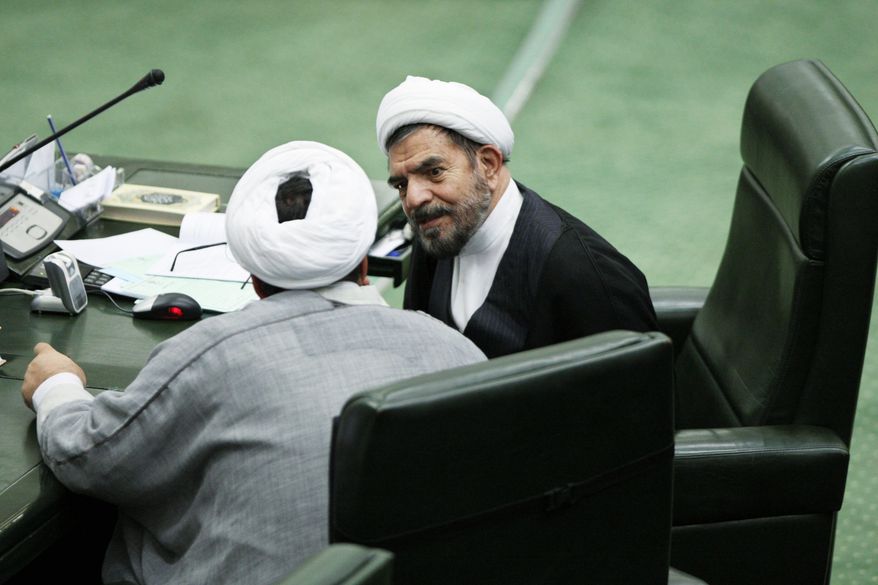 ASSOCIATED PRESS
Iranian cleric lawmaker Hossein Hashemian (right) talks with a colleague in parliament in Tehran on Wednesday. Iran's internal power struggles are shifting into election mode with hard-line political forces banding together to groom candidates for next year's parliamentary elections and punish allies of President Mahmoud Ahmadinejad.