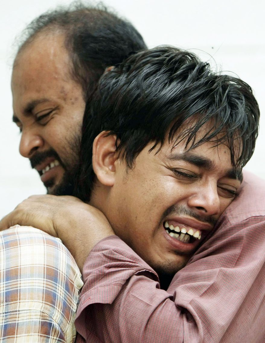 Pakistanis mourn the fatal shooting of their family member in Karachi on Thursday. A wave of violence killed dozens of people in Pakistan's largest city, with many of the victims tortured, shot and stuffed in sacks that were dumped on the streets, officials said. (Associated Press)