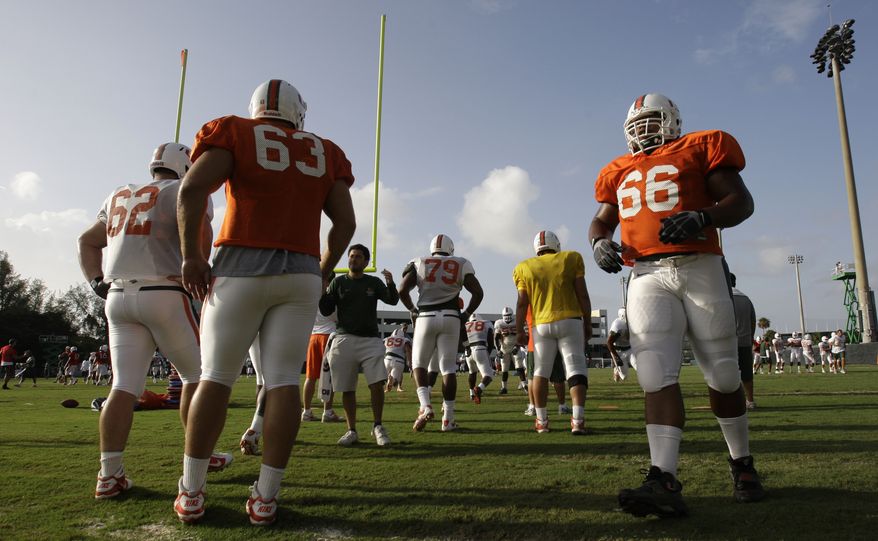Miami offensive lineman Harland Gunn (66) does running drills during football practice in Coral Gables, Fla., Thursday, Aug. 18, 2011. Miami's head coach Al Golden says his team is recovering from the shock of scandalous allegations hitting the program and sparking talk from the NCAA for "fundamental change" in college sports. Also shown are offensive linemen Shane McDermott (62) and Tyler Horn (63). (AP Photo/Lynne Sladky)