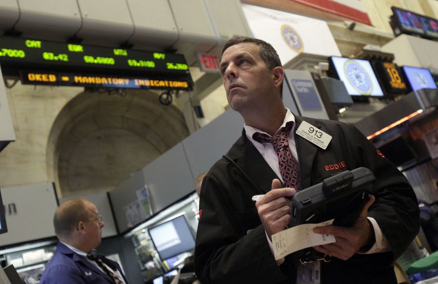 Trader Edward Baumann works on the floor of the New York Stock Exchange in New York on Thursday, Aug. 18, 2011. Worldwide economic gloom was causing markets to tumble. (AP Photo/Richard Drew)