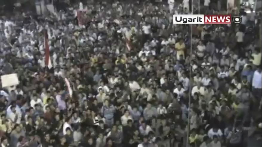 In this image from amateur video made available by the Ugarit News group on Aug. 18 2011, a large crowd gathered Aug. 17 in the town of Rastan near Homs, chanting "Rastan demands the execution of the president" and "We want to fight Bashar." (Associated Press/Ugarit via APTN)