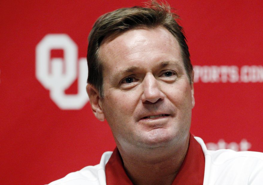 FILE - In this Aug. 6, 2011, file photo, Oklahoma head coach Bob Stoops looks on during Oklahoma football media day in Norman, Okla. The Sooners will start out top-ranked in The Associated Press college football poll for the 10th time, more than any program in the country. (AP Photo/Sue Ogrocki)
