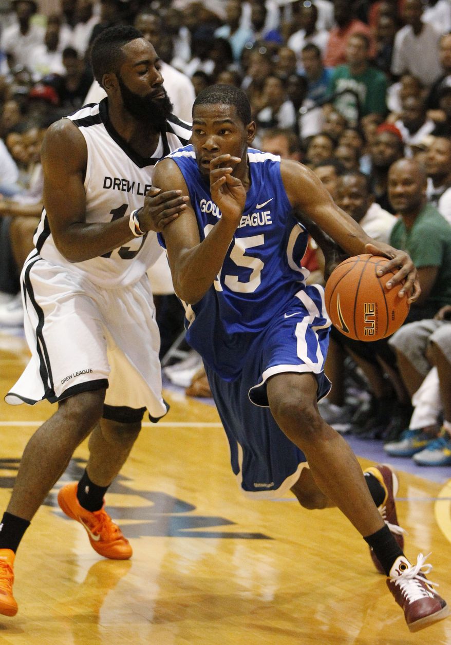 Oklahoma City Thunder's Kevin Durant, playing for Goodman League during the summer, drives on Thunder teammate James Harden, playing for Drew League, during the All-Star game at Trinity University in Washington. The Goodman League's success during the lockout has aided it now. (AP Photo/Charles Dharapak)