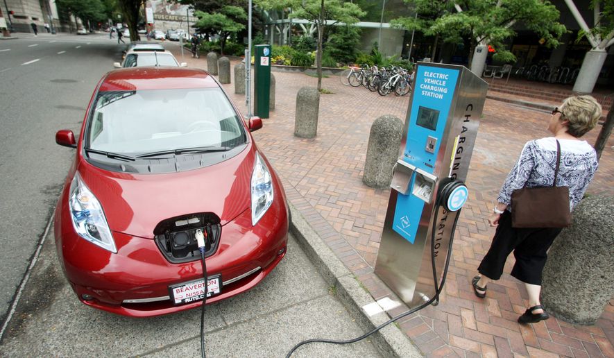 A Nissan Leaf charges at a station in Portland, Ore. (Associated Press)