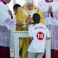 Associated Press
Pope Benedict XVI serves Communion to a girl wearing a T-shirt bearing his name while celebrating Mass at Cuatro Vientos airfield outside Madrid on Sunday. The pope was in Madrid for the four-day World Youth Day event that drew 1.5 million.