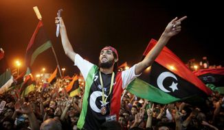LIBERATING LIBYA: Libyans in the rebel-held town of Benghazi, Libya, celebrate the capture in Tripoli of Col. Moammar Gadhafi&#39;s son and one-time heir apparent, Seif al-Islam Gadhafi. The Hague-based International Criminal court wants him extradited to stand trial. (Associated Press)
