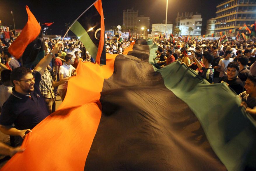 Euphoric fighters celebrated with residents of Benghazi in the city's main square, the symbolic heart of the regime. (AP Photo/Alexandre Meneghini)
