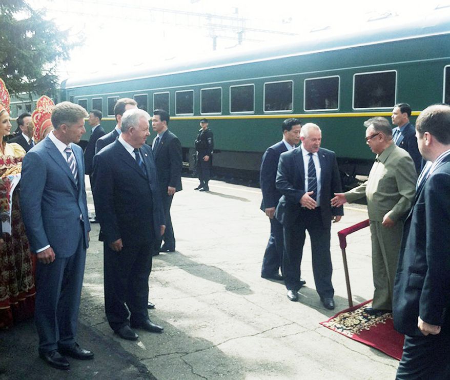 North Korean leader Kim Jong-il (second right) steps down from his armored train upon his arrival at the Bureya railway station in eastern Siberia on Sunday. Mr. Kim crossed into Russia on his armored train Saturday at the invitation of President Dmitry Medvedev. The two leaders are expected to meet later in the week to discuss the restart of nuclear-disarmament talks and the construction of a pipeline that would stream Russian natural gas to North and South Korea. (Associated Press)