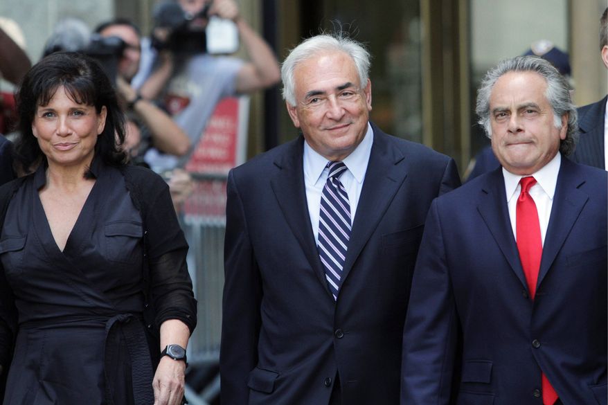 ASSOCIATED PRESS
Former International Monetary Fund leader Dominique Strauss-Kahn (center) leaves Manhattan state Supreme Court with his wife, Anne Sinclair, and attorney Benjamin Brafman after a hearing Tuesday in New York. A New York judge dismissed the sexual assault case against Mr. Strauss-Kahn.