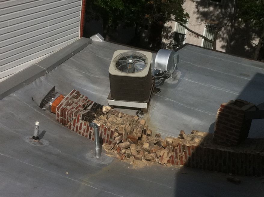 A rowhouse at 5th Street and Florida Ave., NW has roof damage after its chimney collapses as a result of a 5.8 earthquake in Virginia has been felt in Washington, D.C., Tuesday, August 23, 2011. (Andrew Harnik / The Washington Times)