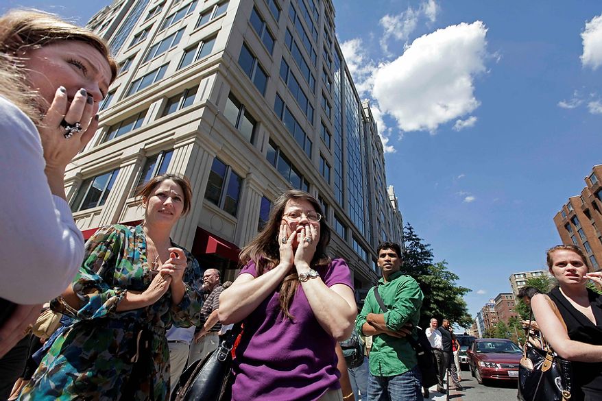 Office workers gather on the sidewalk in downtown Washington on Aug. 23, 2011, moments after a 5.9 magnitude tremor shook the nation's capitol. The earthquake centered northwest of Richmond, Va., shook much of Washington, D.C., and was felt as far north as Rhode Island and New York City. (Associated Press)