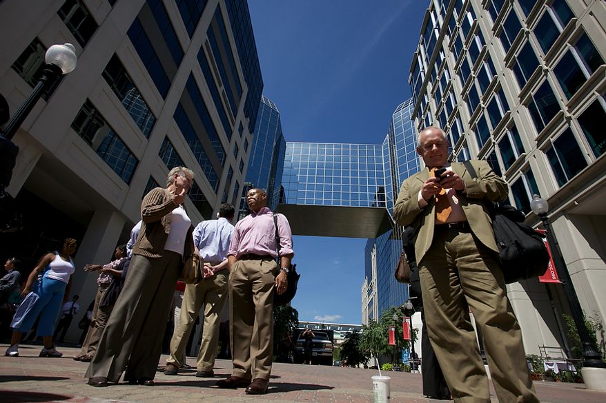 Office workers try to use their cellphones in Chinatown in Northwest after a 5.9 earthquake in Virginia is felt in Washington, D.C., Tuesday, August 23, 2011. (Andrew Harnik / The Washington Times)