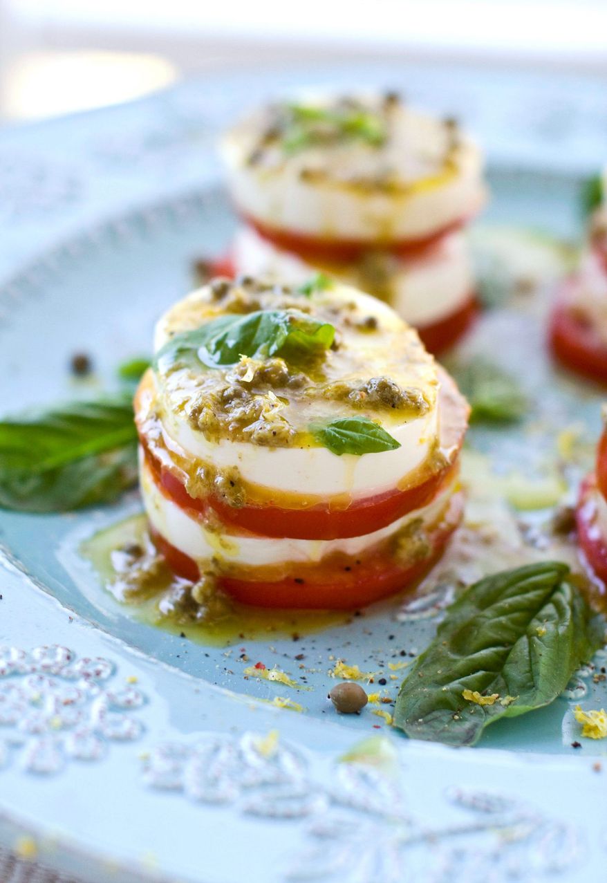Tomatoes and fresh mozzarella are the star ingredients of caprese salad. To add a punch of tang, capers were added to the vinaigrette and a few more were sprinkled over the salad just before serving. (Associated Press)