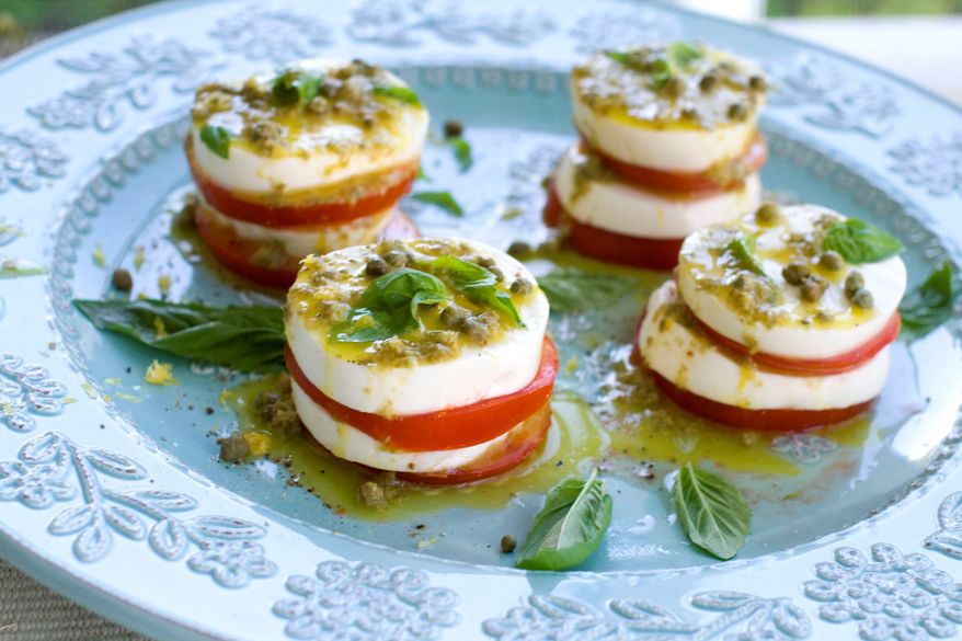 Tomatoes and fresh mozzarella are the star ingredients of caprese salad. To add a punch of tang, capers were added to the vinaigrette and a few more were sprinkled over the salad just before serving. (Associated Press)
