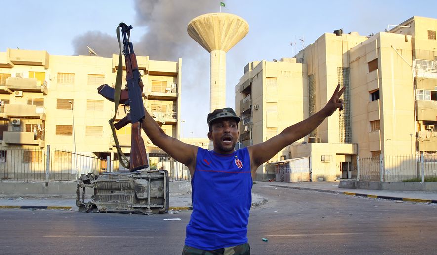 A Libyan rebel gestures in Abu Salim district in Tripoli, Libya, on Aug. 25, 2011. (Associated Press)