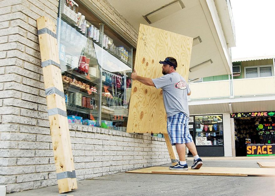 Rob Auker boards up Souvenir City in Ocean City, Maryland as Hurricane Irene approaches on Thursday August 25, 2011. (AP Photo/The Daily Times, Eric Doerzbach) NO SALES