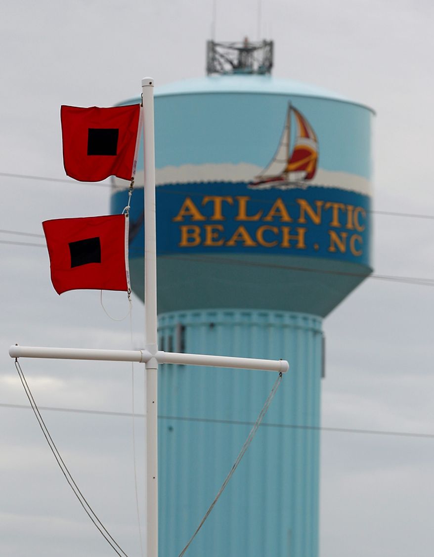 Hurricane warning flags fly in Atlantic Beach, N.C., Friday, Aug. 26, 2011, as Hurricane Irene heads toward the North Carolina coast. (AP Photo/Chuck Burton) ** FILE **